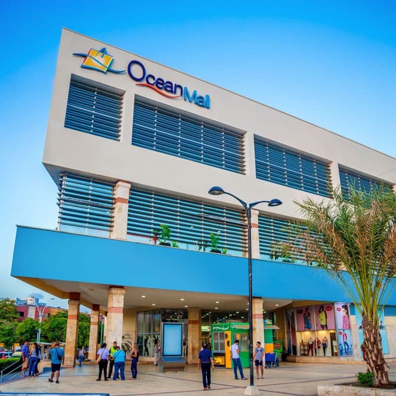 3 story office building-type building with large windows. Sign at the top corner of the building says "Ocean Mall"